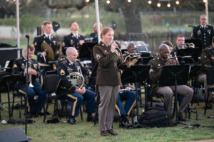 Staff Sergeant Kayla Winslow, a soloist with the 323rd Army Band, performs as part of Friday night activities at Fort Martin Scott. Here, Winslow performs a medley of military service songs, which featured five branches of the military. — Standard-Radio Post/Ken Esten Cooke